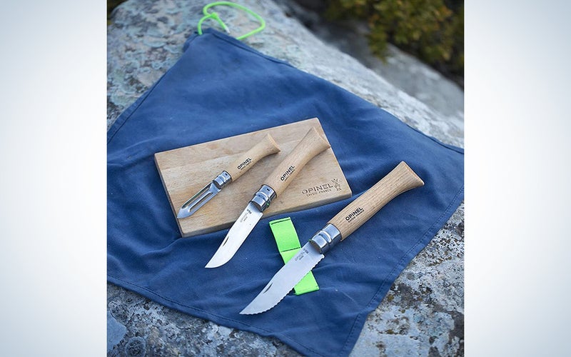 An Opinel Nomad camping utensil kit on a rock