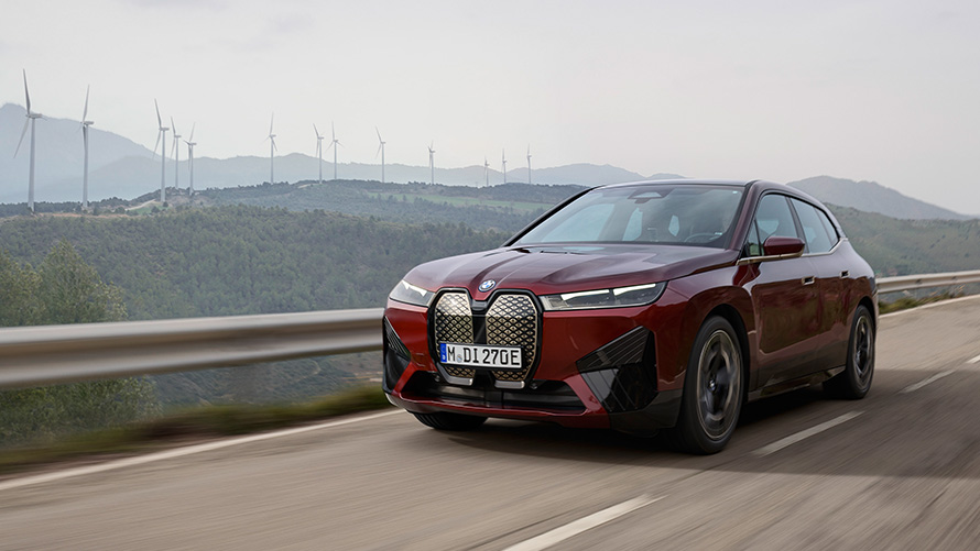 BMW iX xDrive50 i20 electric SUV sustainability BMW iX xDrive50 i20 2021 electric SUV driving on coastal road sustainability