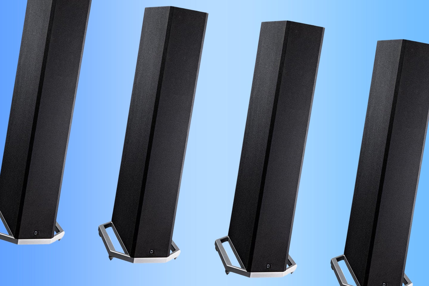 A lineup of Definitive tower speakers on a blue and light blue background