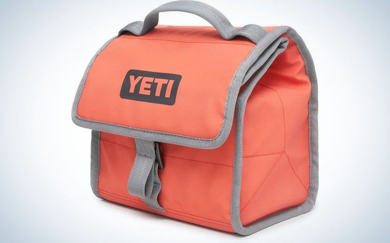A small red bag with grey lines into it and written YETI with capital letters.