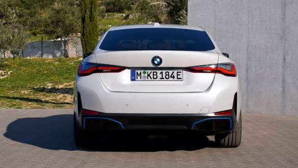 Rear view of BMW i4 eDrive40 G26 2021 parking BMW i4 eDrive40 G26 2021 Mineral White rear view parking
