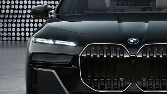 Striking front design BMW M760e xDrive Sedan G70 Bonnet and kidney with M logo BMW M760e xDrive Sedan G70 BMW Individual two-tone Black Sapphire metallic paintwork BMW Individual Dravite Grey metallic close-up